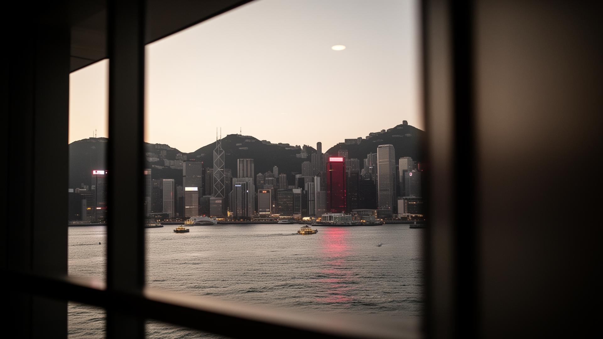 Hong Kong harbour at dusk viewed through an architectural window